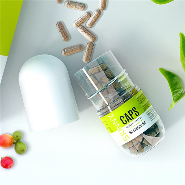 SKINNY GREEN CAPS on table with some capsules spread out the bottle