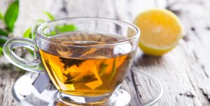 skinny tea in a tea cup with lemon in the background