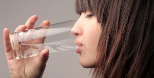 woman drinking a glass of water