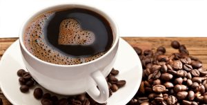 cup of coffee amongst coffee beans